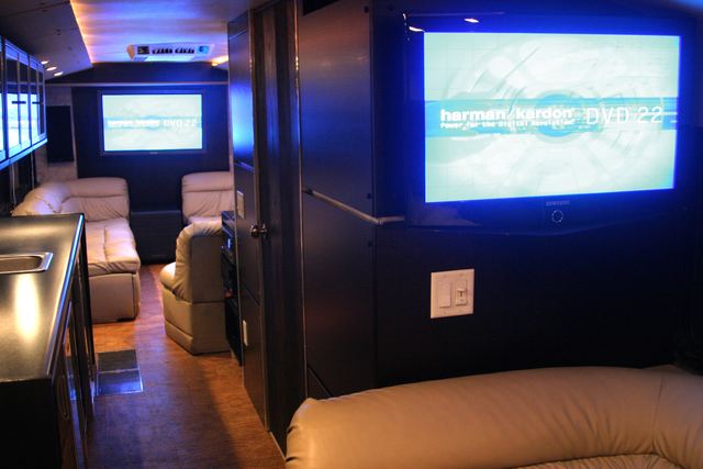 Wide view of the lounge with a flat panel and the bar